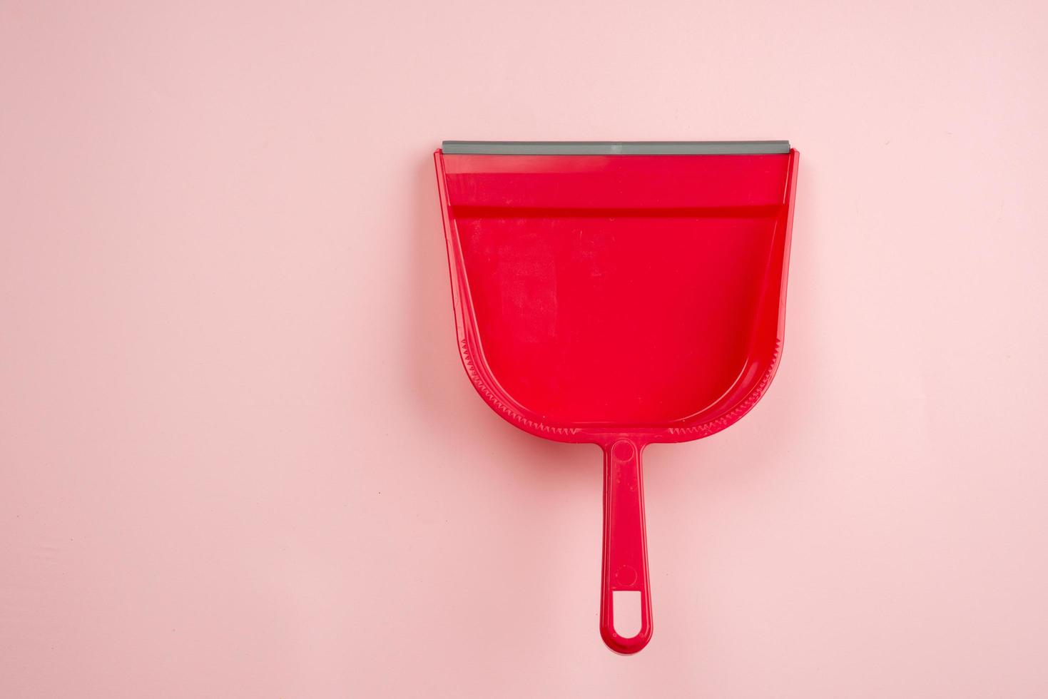 Top view of red plastic dustpan isolated on white background photo