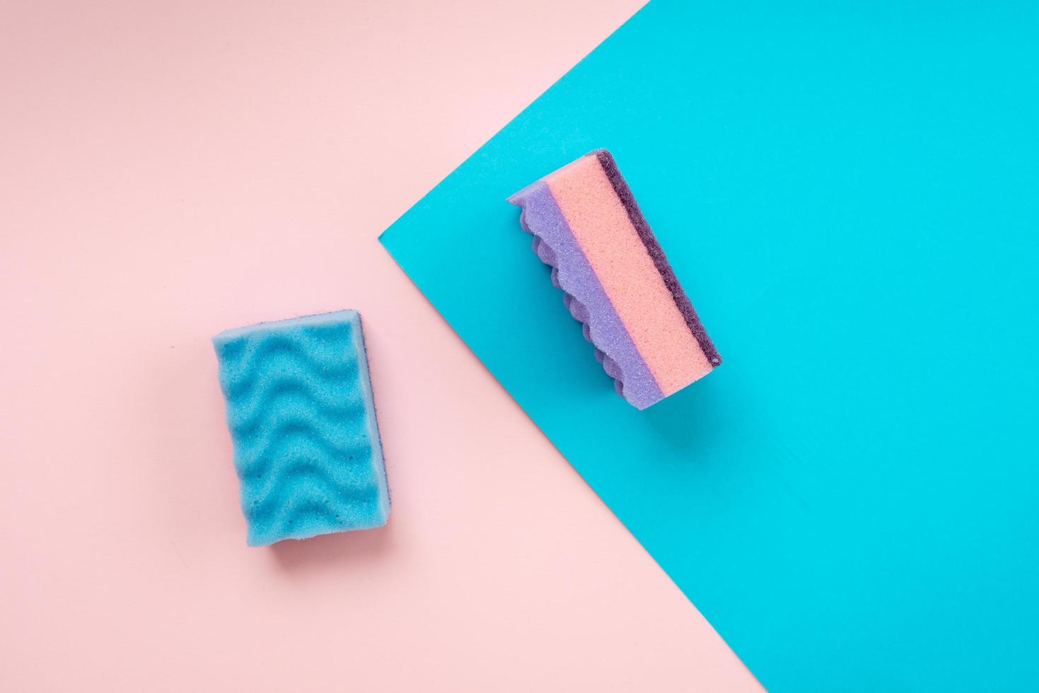 Multicolored kitchen washcloths laid on a pink and blue background photo