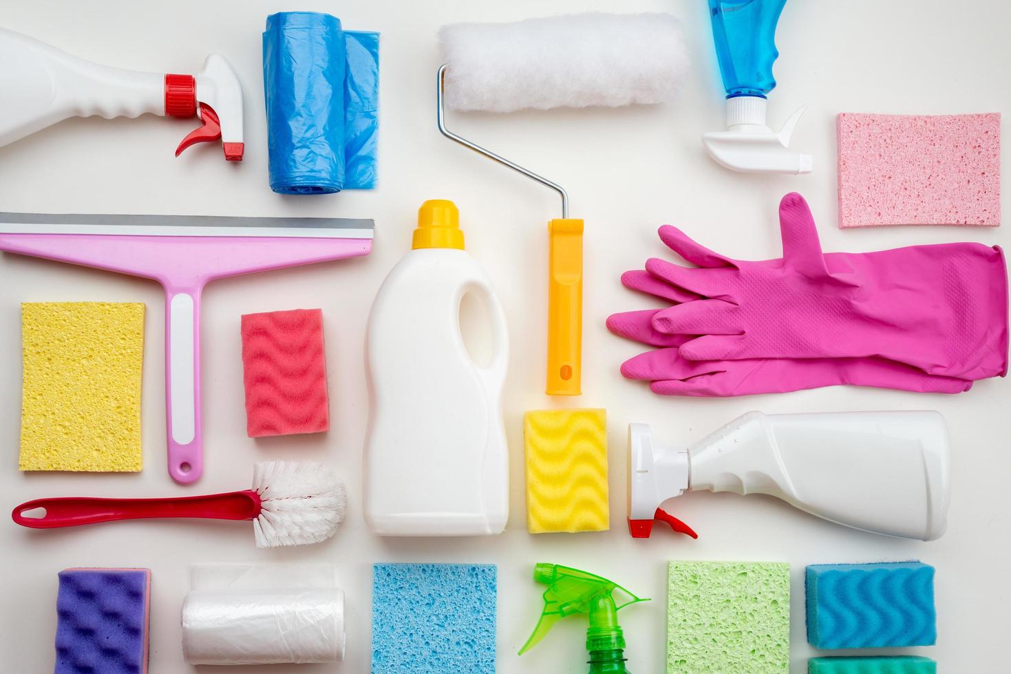 Cleaning items are laid out on a white surface photo