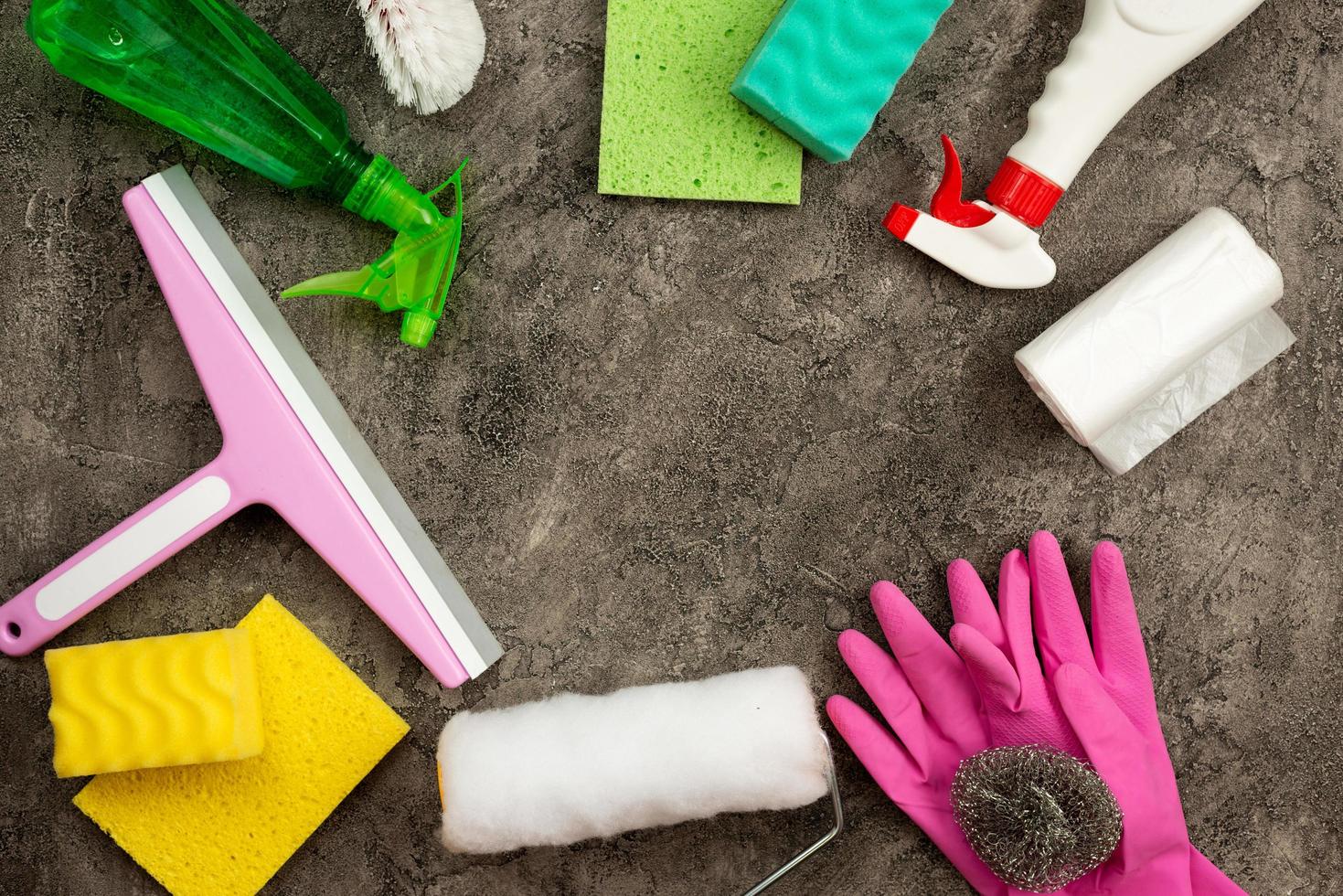 Household accessories lying in a circle on a background of gray decorative plaster. Copy the space photo