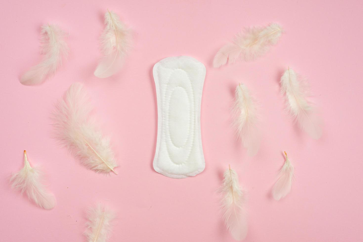 On a pink background, women's daily pads with cotton cover. photo