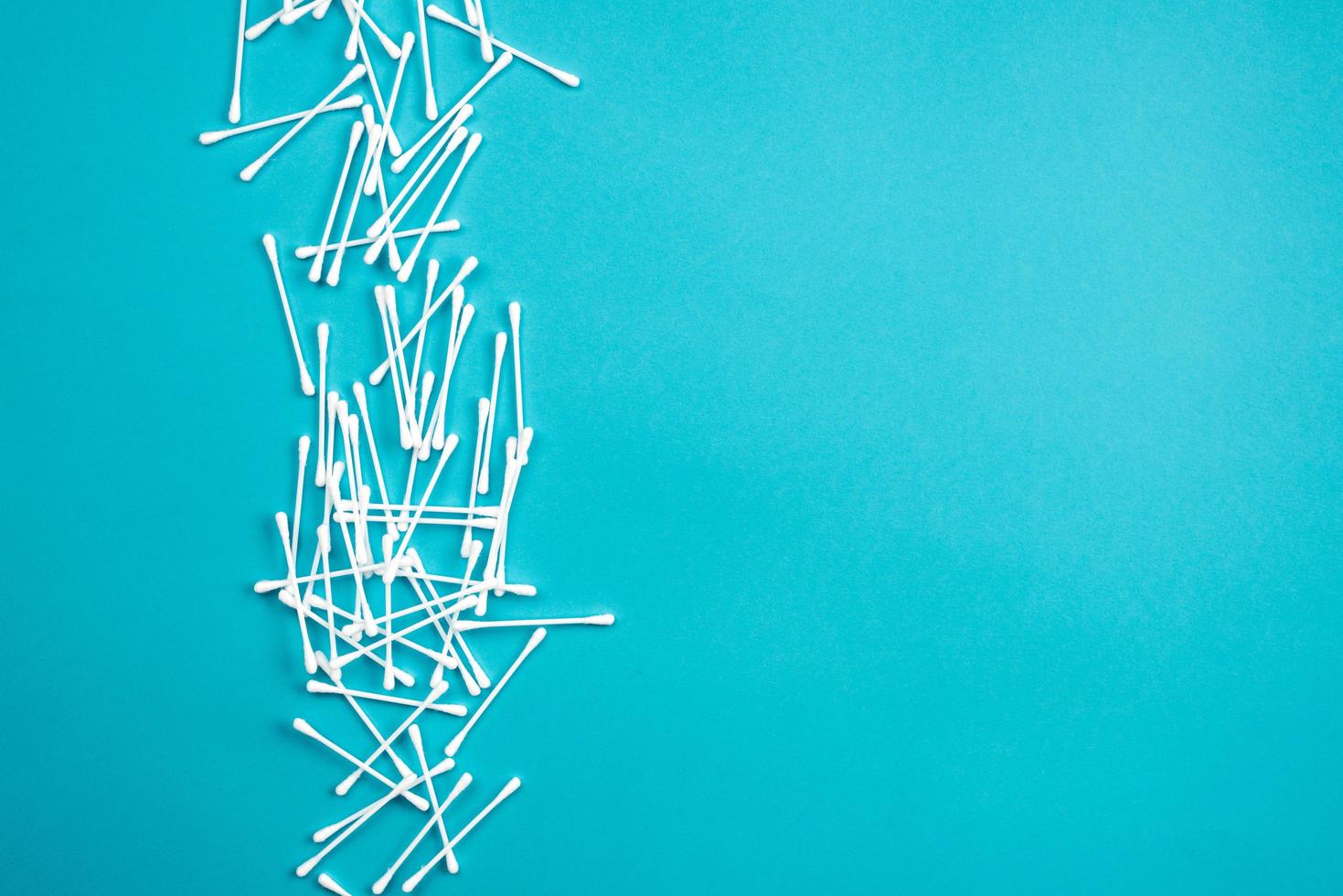 Cotton ear sticks on blue background. Cotton ear sticks isolated on blue background photo