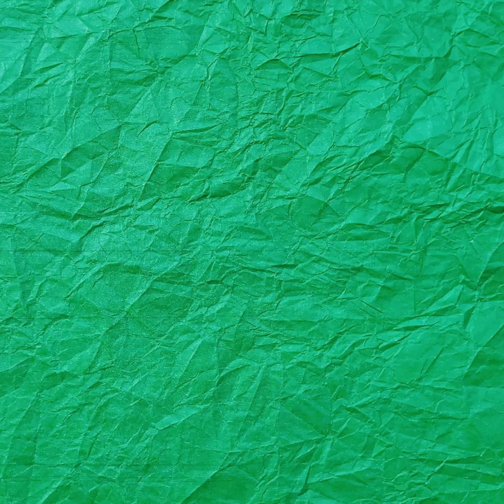 Realistic crumpled green paper texture background vector