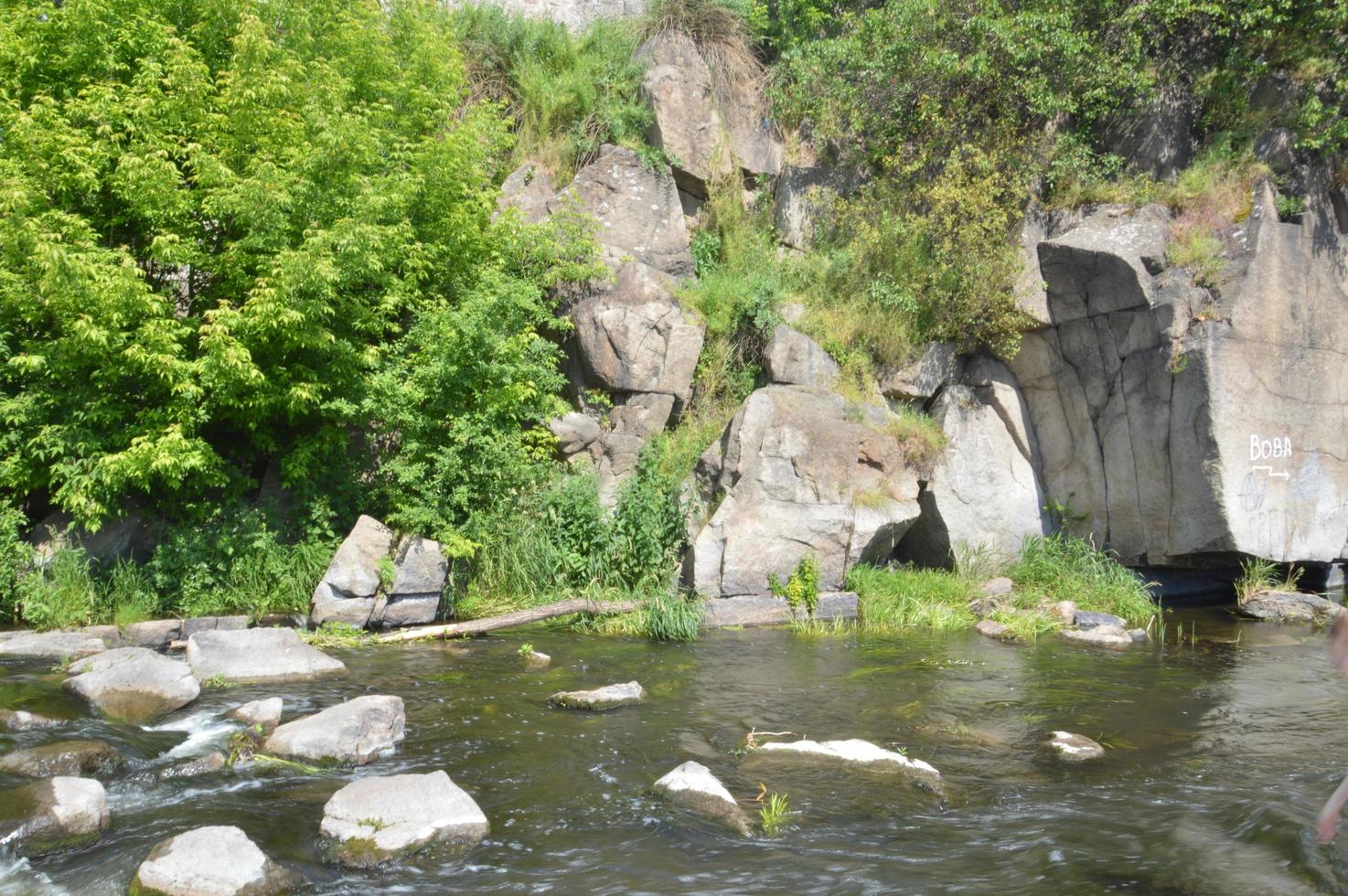 un río de montaña fluye con bancos de piedra foto