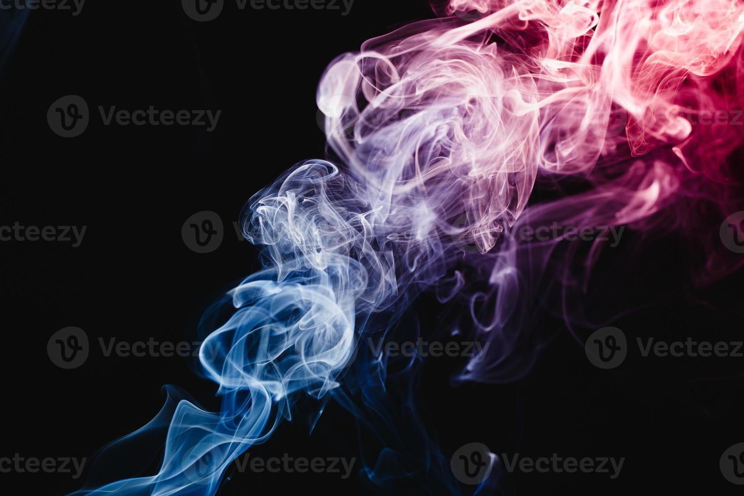 Smoke floating on dark background photo