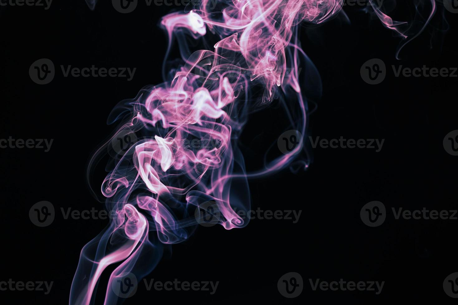 Smoke floating on dark background photo