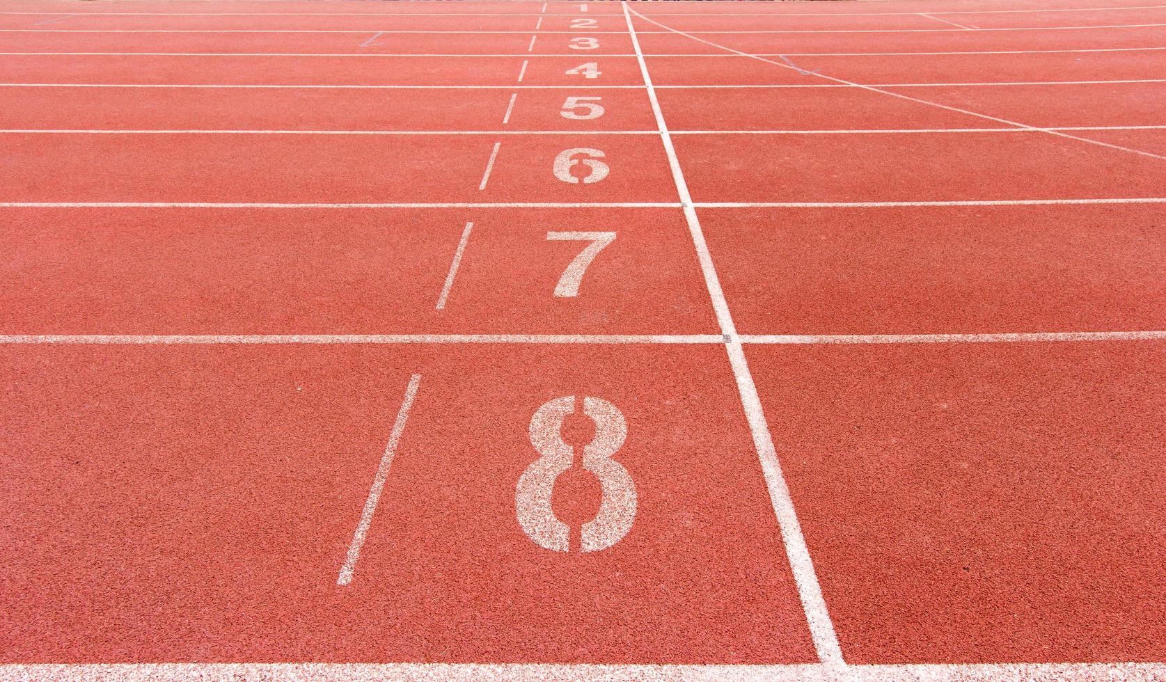 Numbered running track in stadium photo