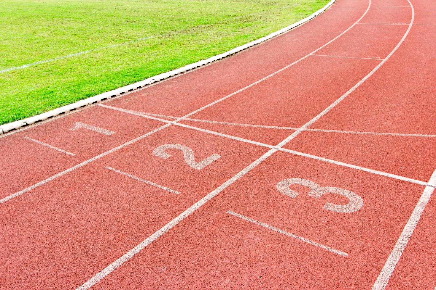 Numbered running track in stadium photo