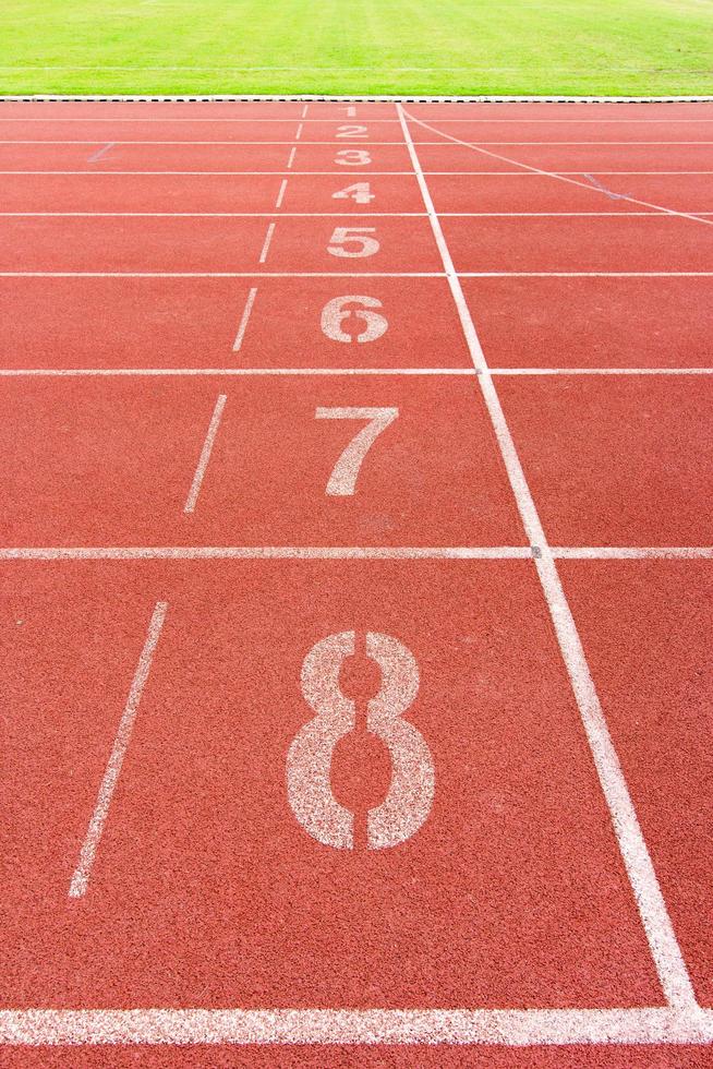 Numbered running track in stadium photo