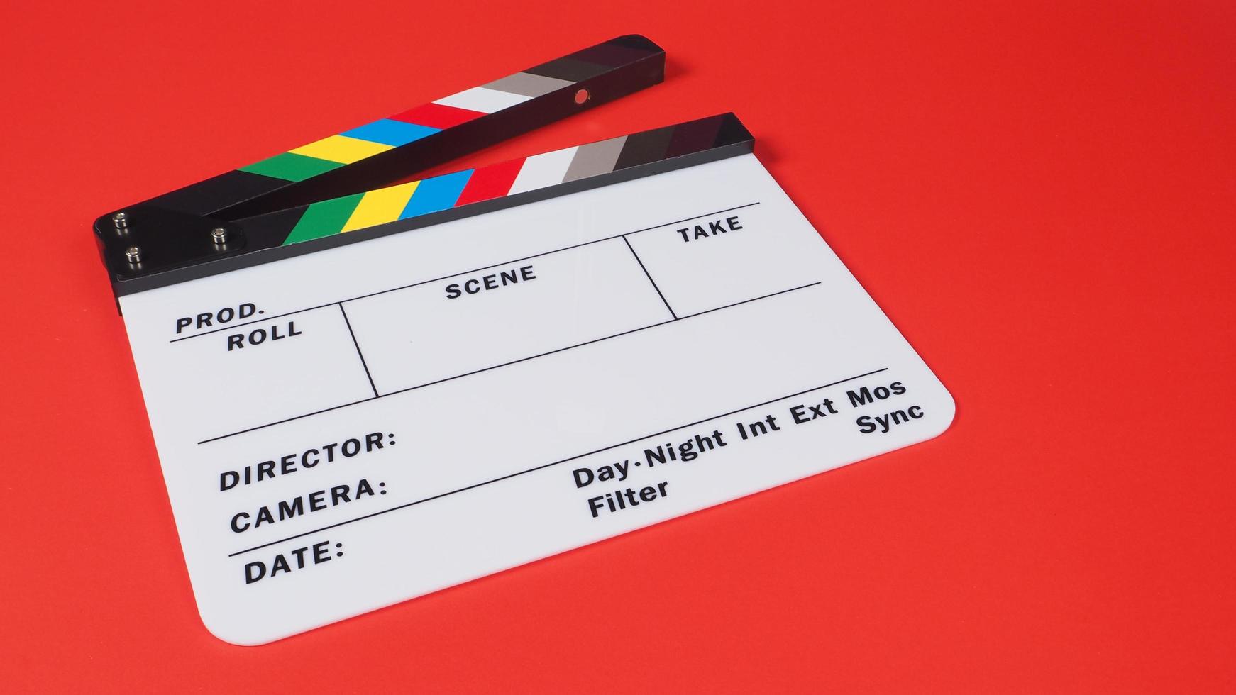 Clapperboard or movie slate on red background.it use in video production and film industry . photo