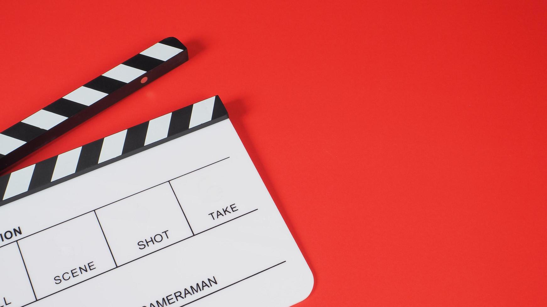 Clapperboard or movie slate on red background.it use in video production and film industry . photo