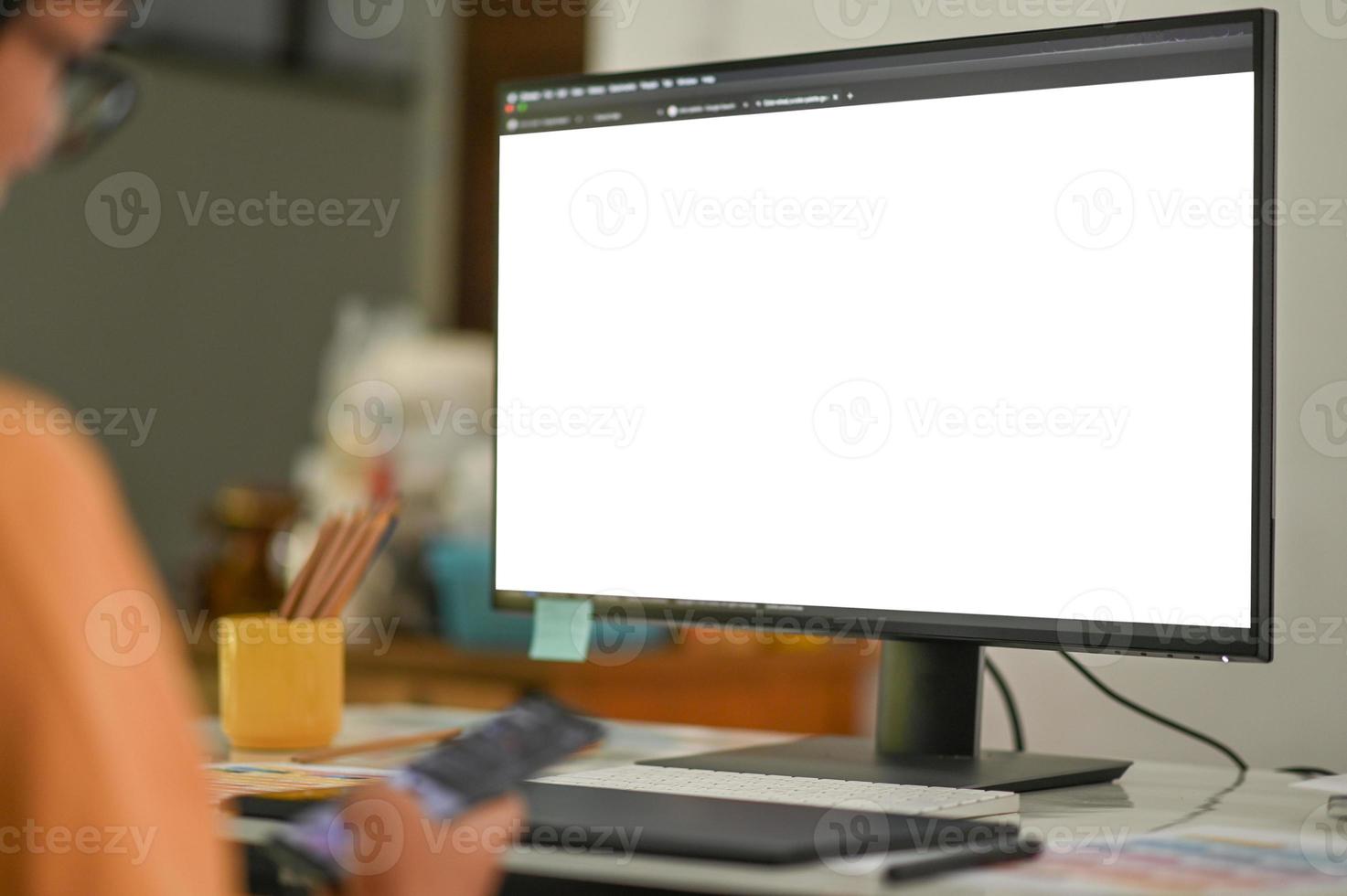 Programmer and mockup blank screen computer on a programming desk. photo
