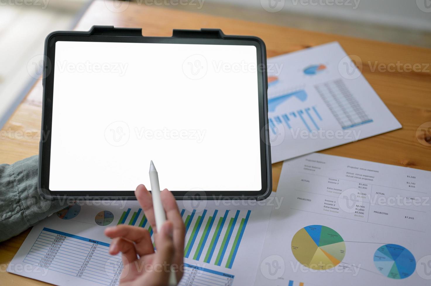 Experts are using a tablet to check the company earnings. photo