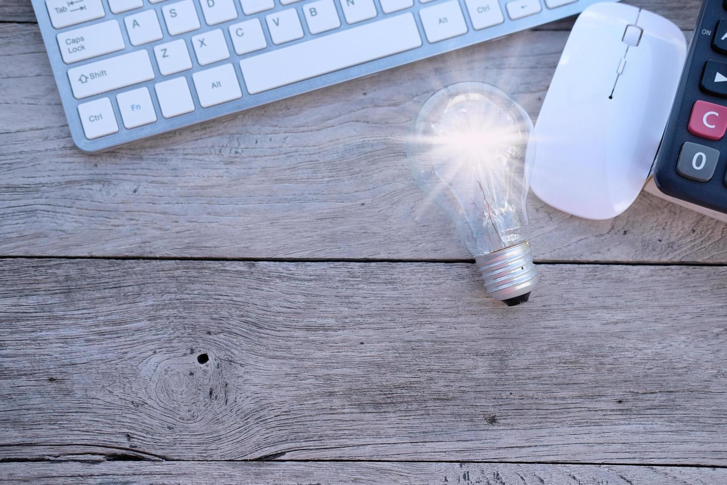 Idea innovation and inspiration concept. illuminated light bulb on table, concept photo