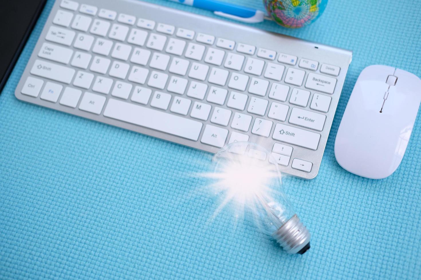 Idea innovation and inspiration concept. illuminated light bulb on table, concept photo