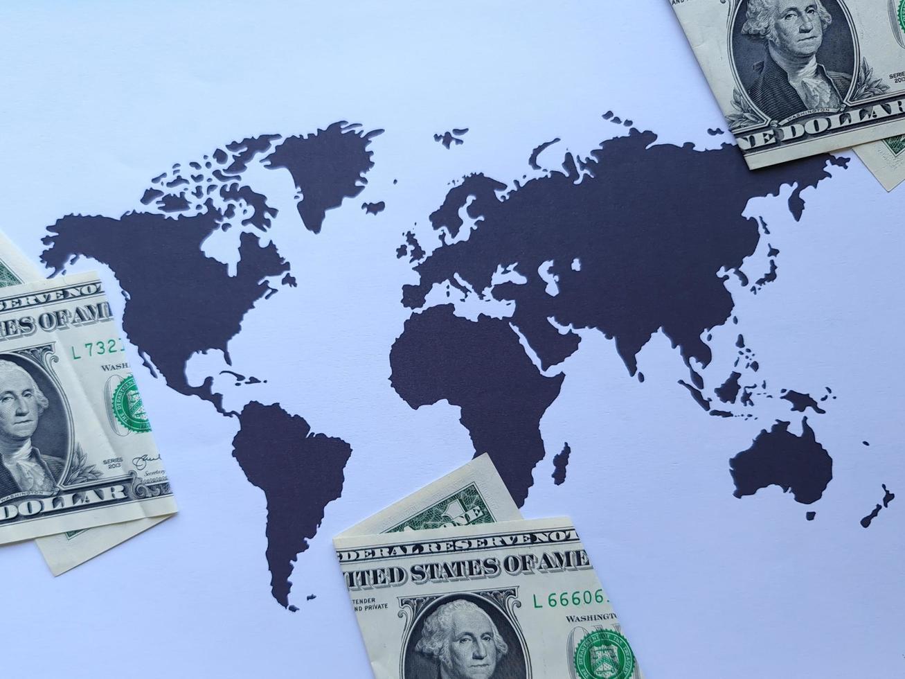 American one dollar bills and background with a world map in black and white photo