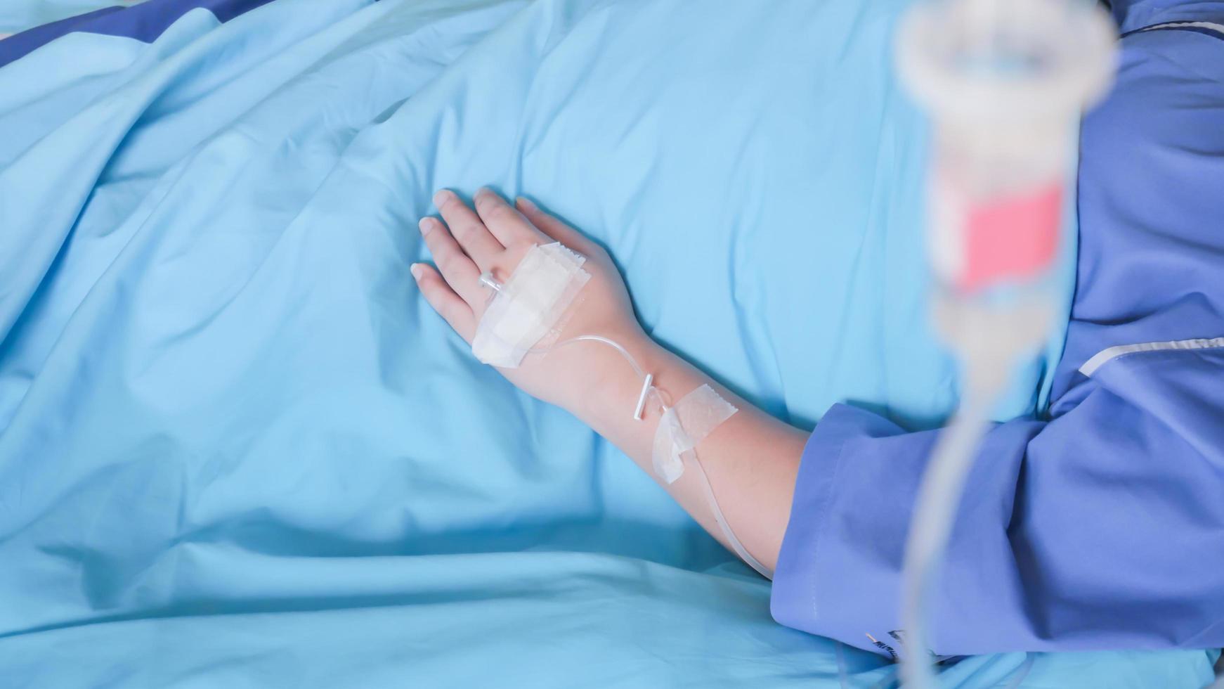 Patient in hospital with saline intravenous IV, saline into the body for treatment photo