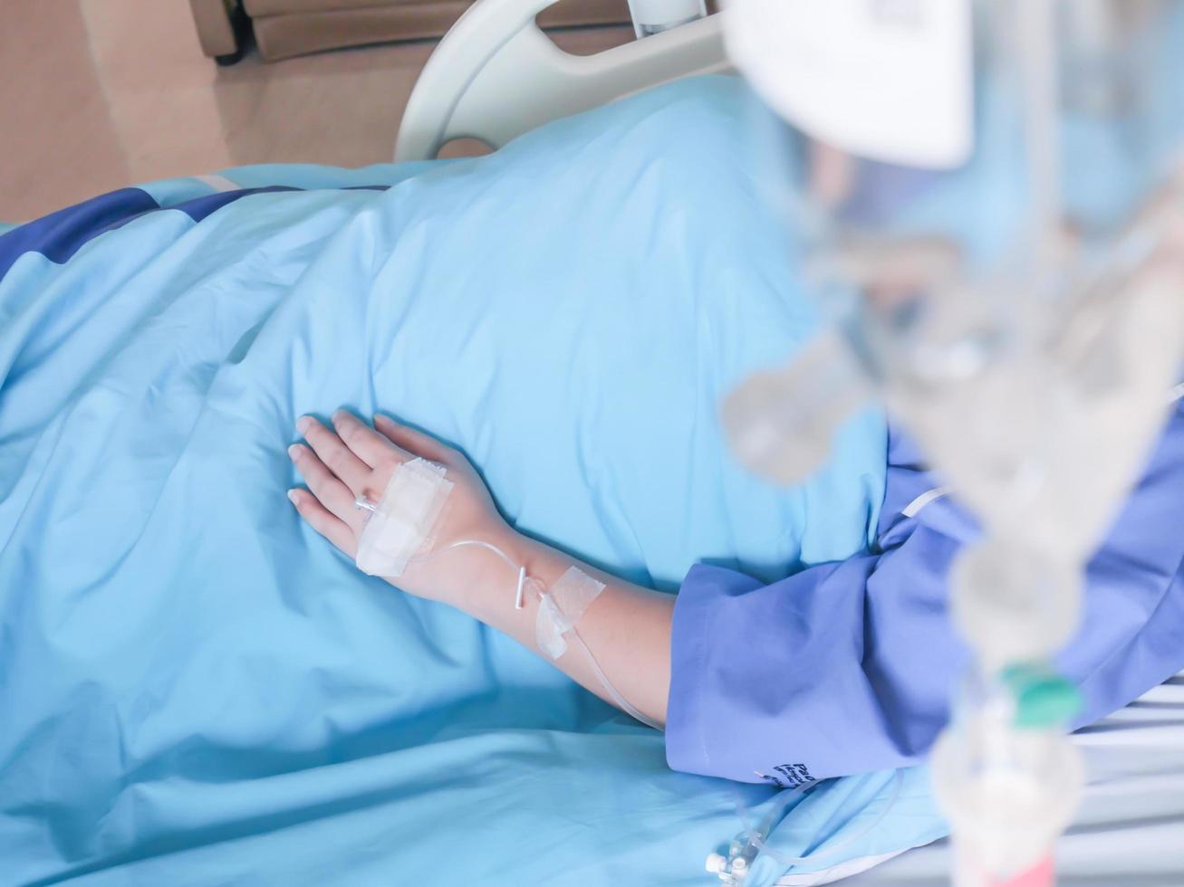 Patient in hospital with saline intravenous IV, saline into the body for treatment photo