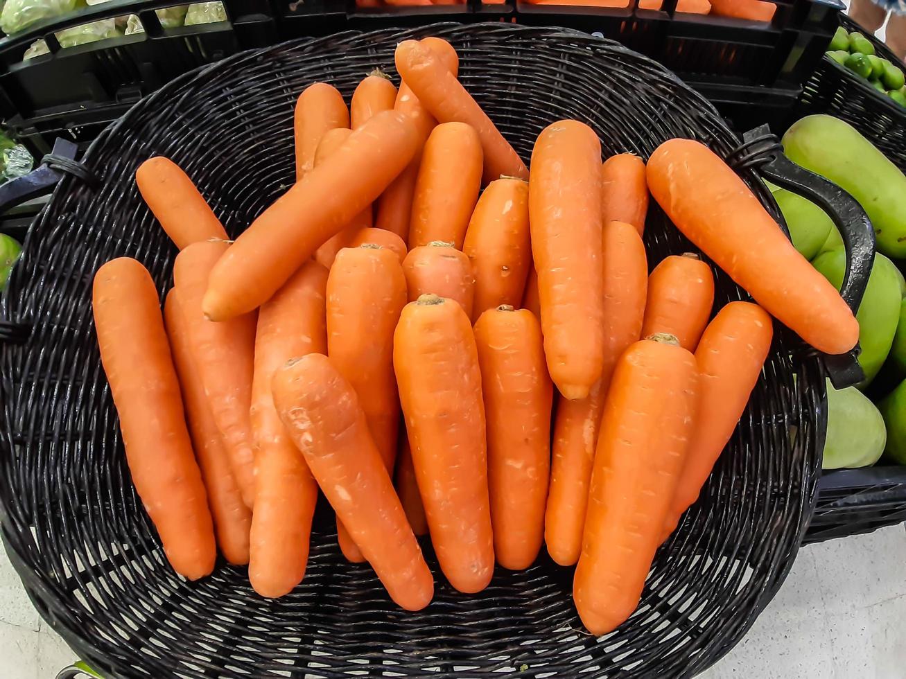 Organic carrot. Texture background of fresh large orange carrots, carrots are good for health, healthy ripe carrot for preparing meal photo