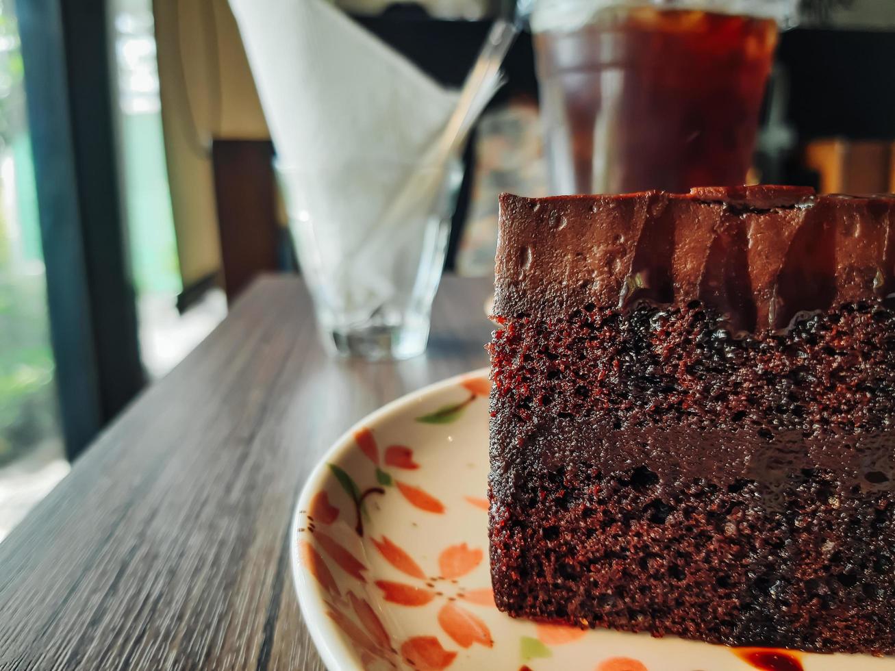 Plate with slice of tasty homemade chocolate cake on table, delicious chocolate cake. Piece of Cake on a Plate. Sweet food. Sweet dessert. Close up. photo