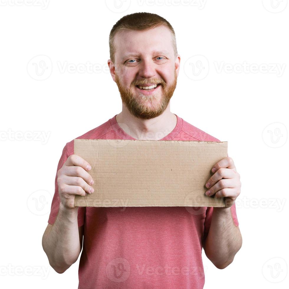 Bearded man with a cardboard sign in his hand photo