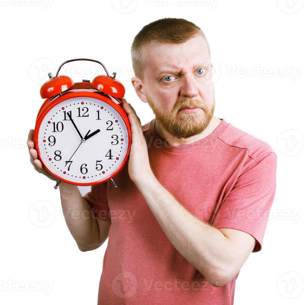 Unhappy man with a red alarm clock in his hand photo