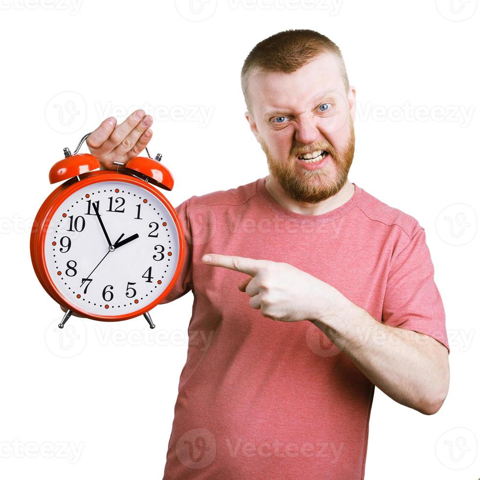 Disgruntled man holding a big alarm clock photo