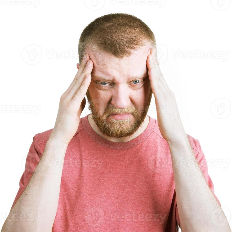 Bearded man holds on to his head photo