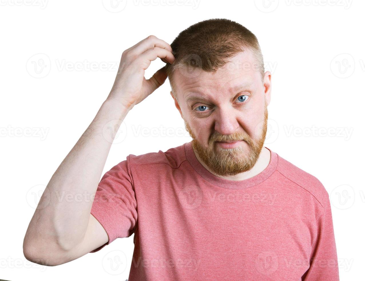 Bearded man scratches his head hair photo