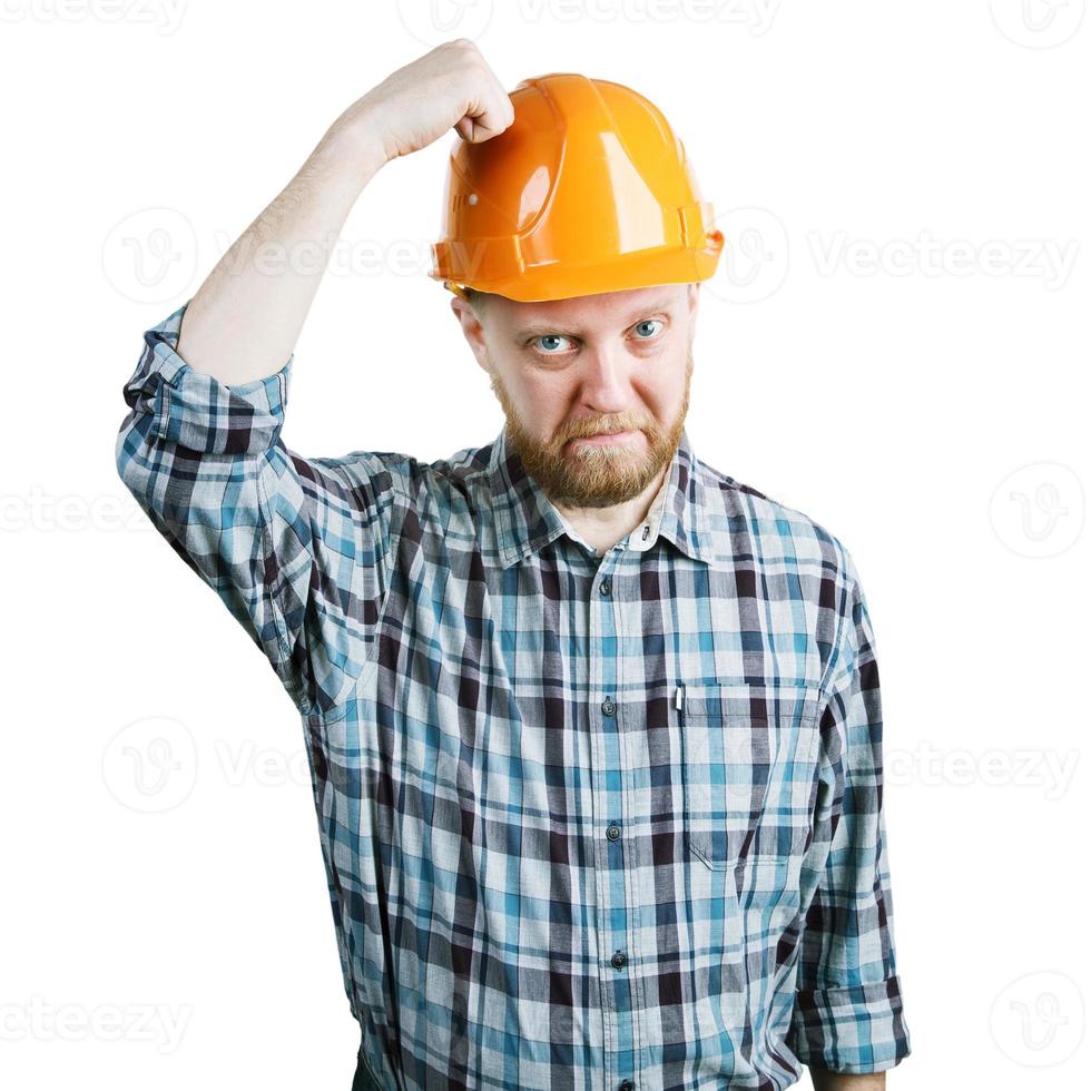 Man bangs his hand on protective helmet photo