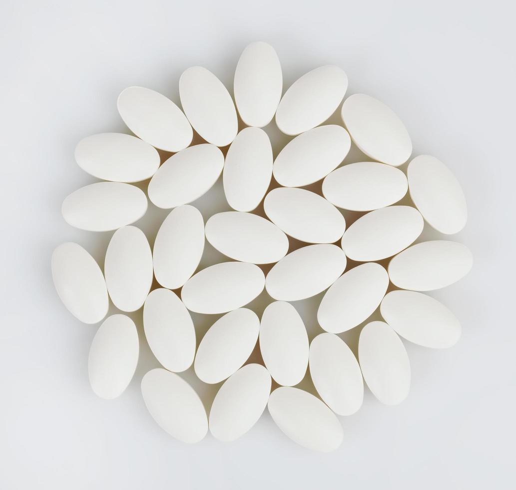 White pills on a white background photo