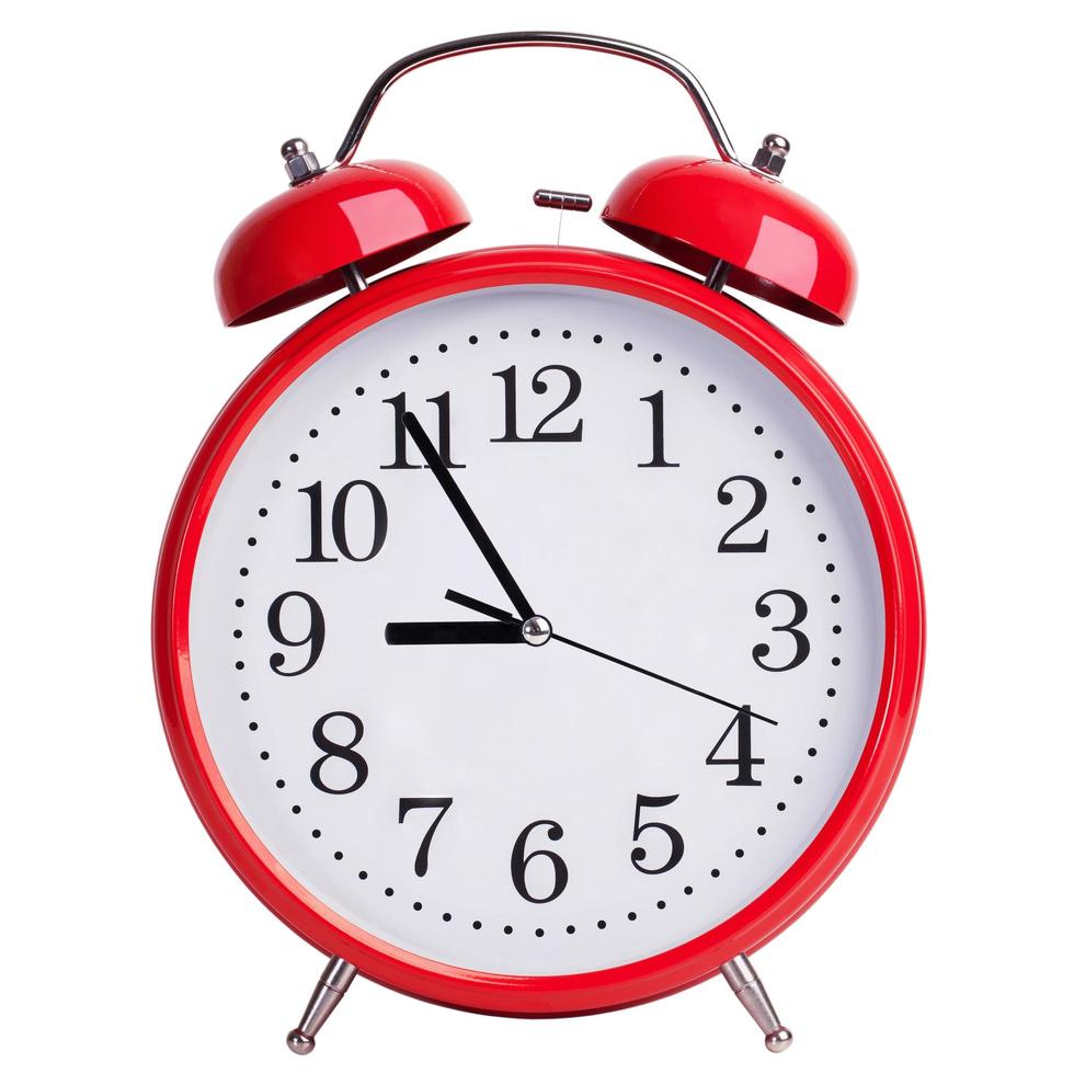 reloj despertador redondo que muestra de cinco a nueve foto