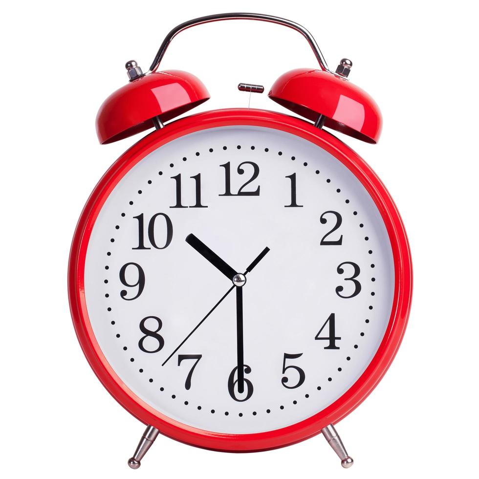 Red alarm clock shows half past ten photo