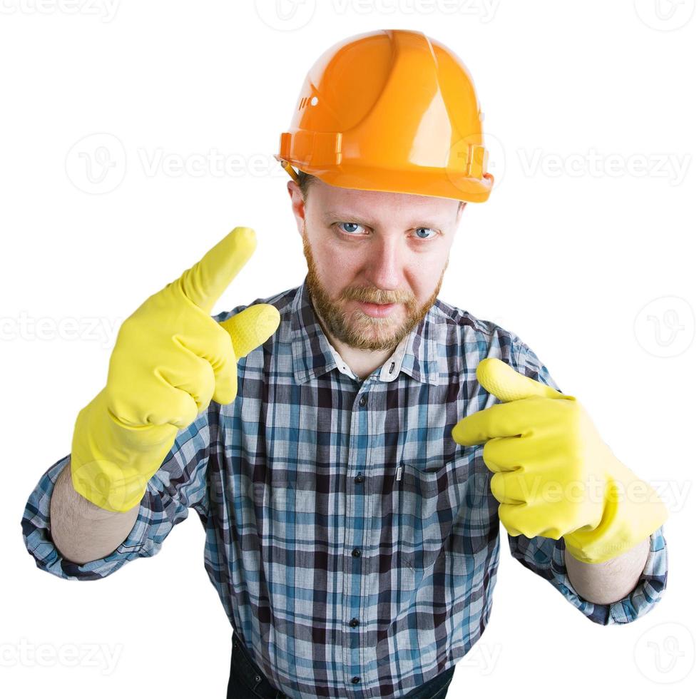 hombre en un casco y guantes amarillos foto