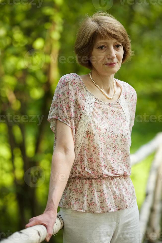 Thoughtful beautiful elderly woman photo