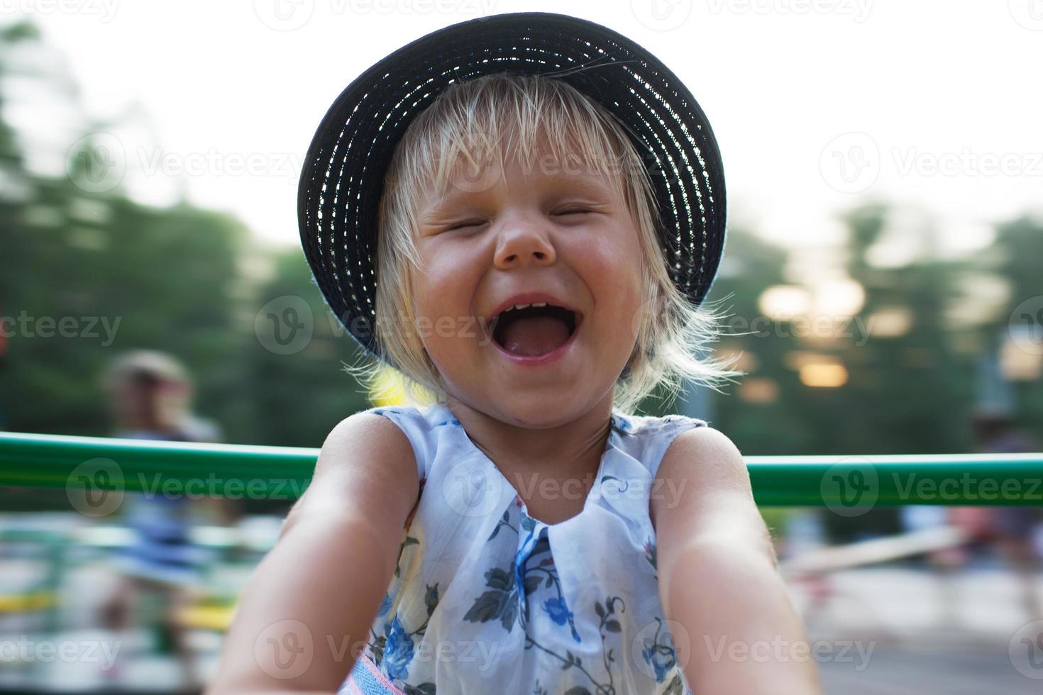 Little girl cheerfully laughs photo