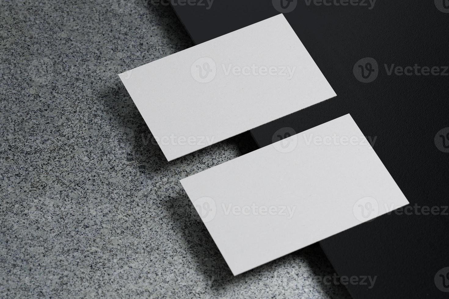 White horizontal business card paper mockup template with blank space cover for insert company logo or personal identity on black cardboard floor background. Modern concept. 3D illustration render photo