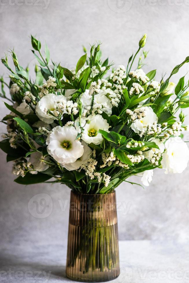 Beautiful white eustoma flowers in bouquet photo