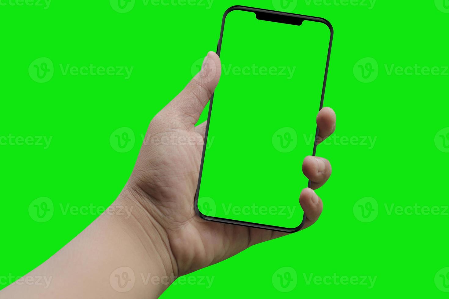 moderno teléfono inteligente en la mano. pantalla verde y fondo foto