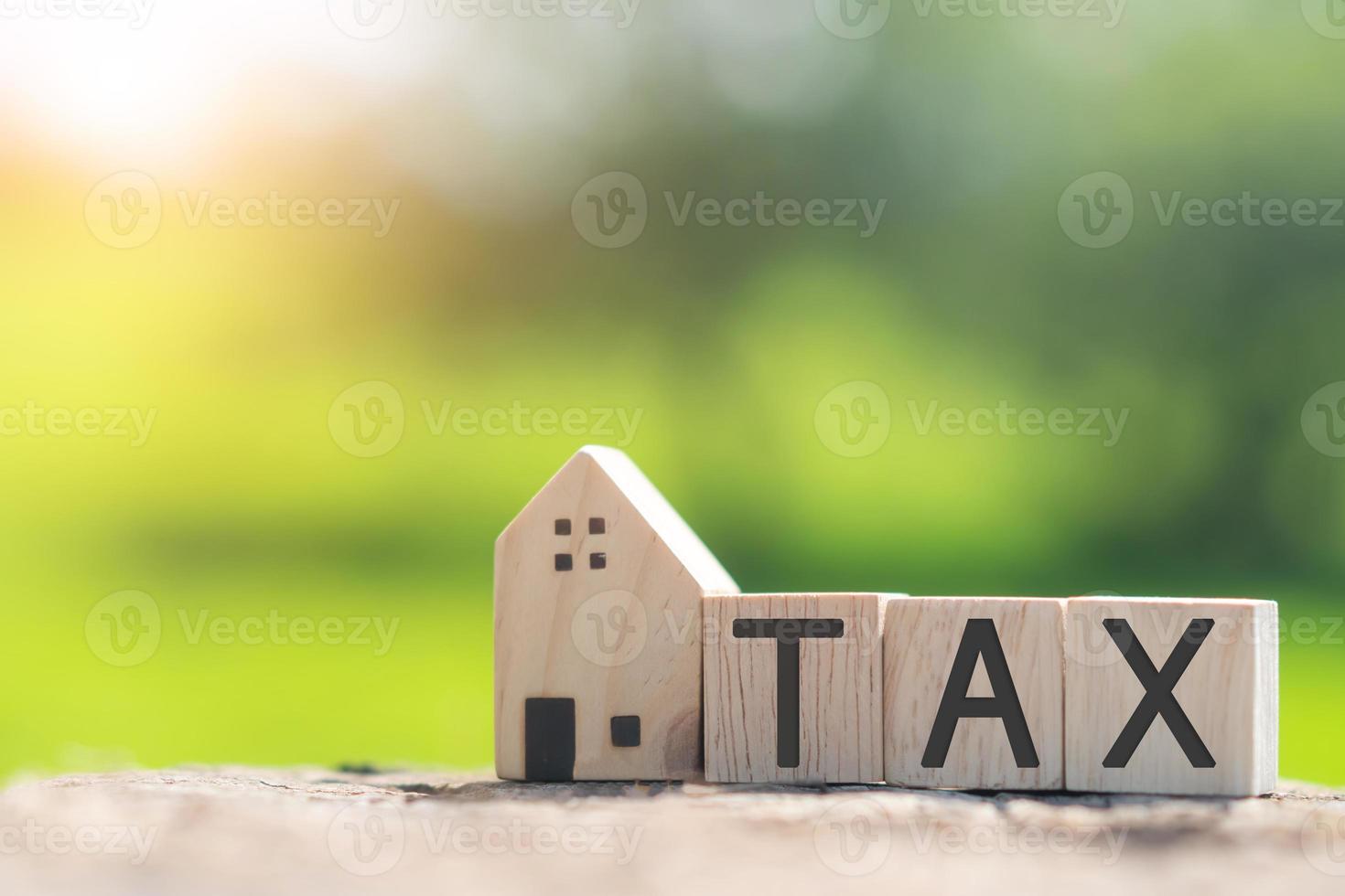 On a wooden cube background, the word tax appears. The concept of a business financial loan. photo