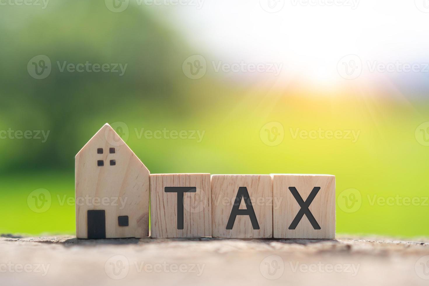 On a wooden cube background, the word tax appears. The concept of a business financial loan. photo