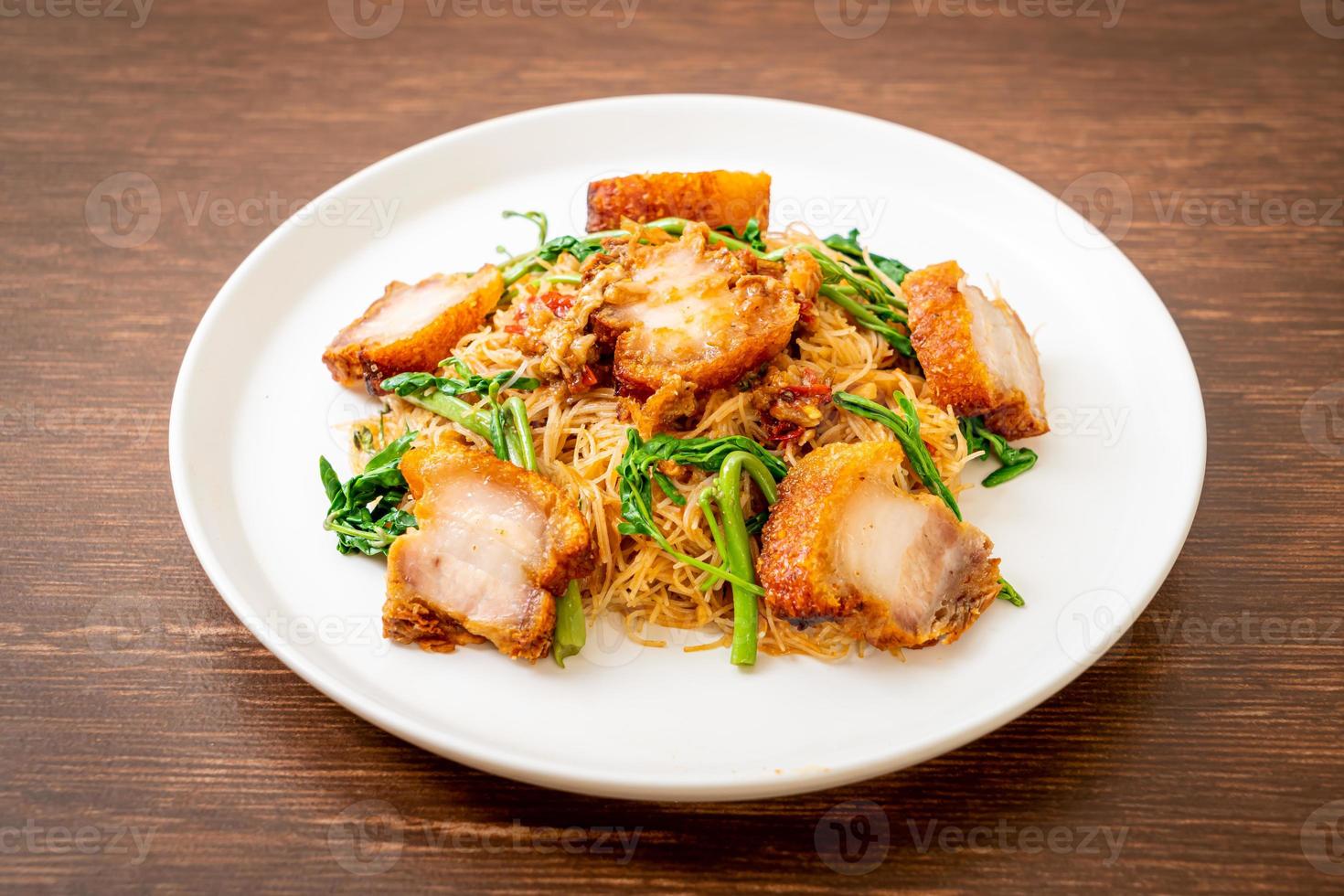 Stir-fried rice vermicelli and water mimosa with crispy pork belly photo