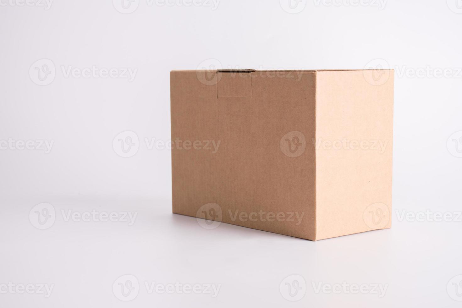 Brown paper box on white background. Parcel and post delivery concept. Object and container theme photo