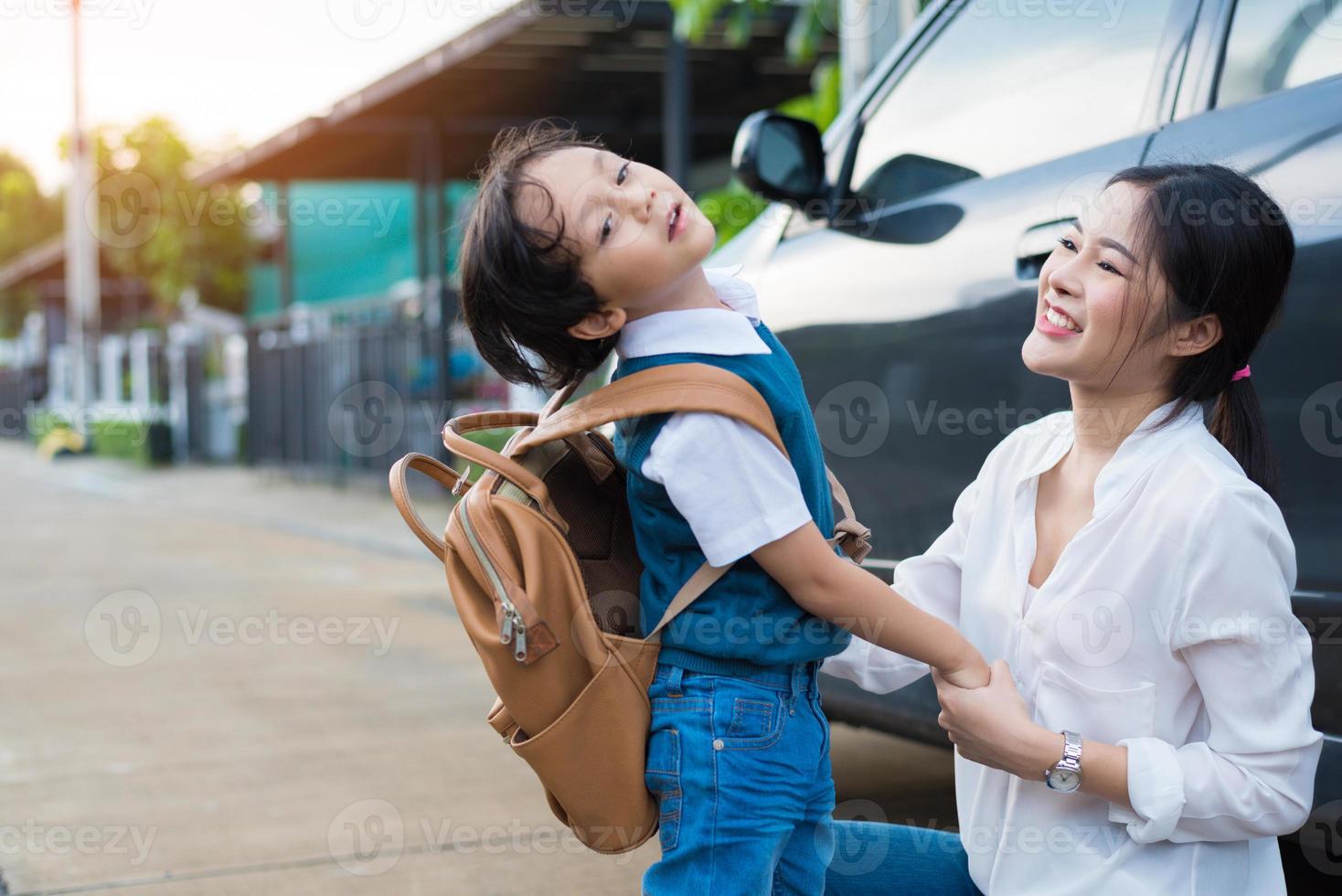 Mom send naughty boy before going to school in morning. Happy family and Lifestyles concept. Education and Back to school theme photo