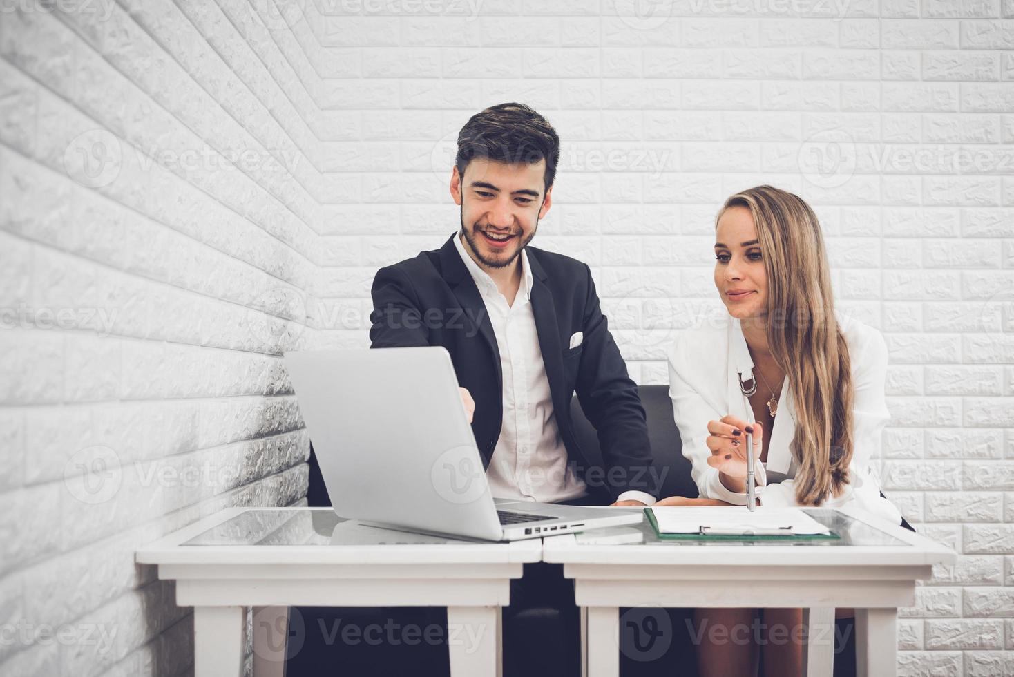 Businessman and business woman analyzing income charts and graphs in coffee shop. Business analysis and strategy concept. Indoors office theme photo