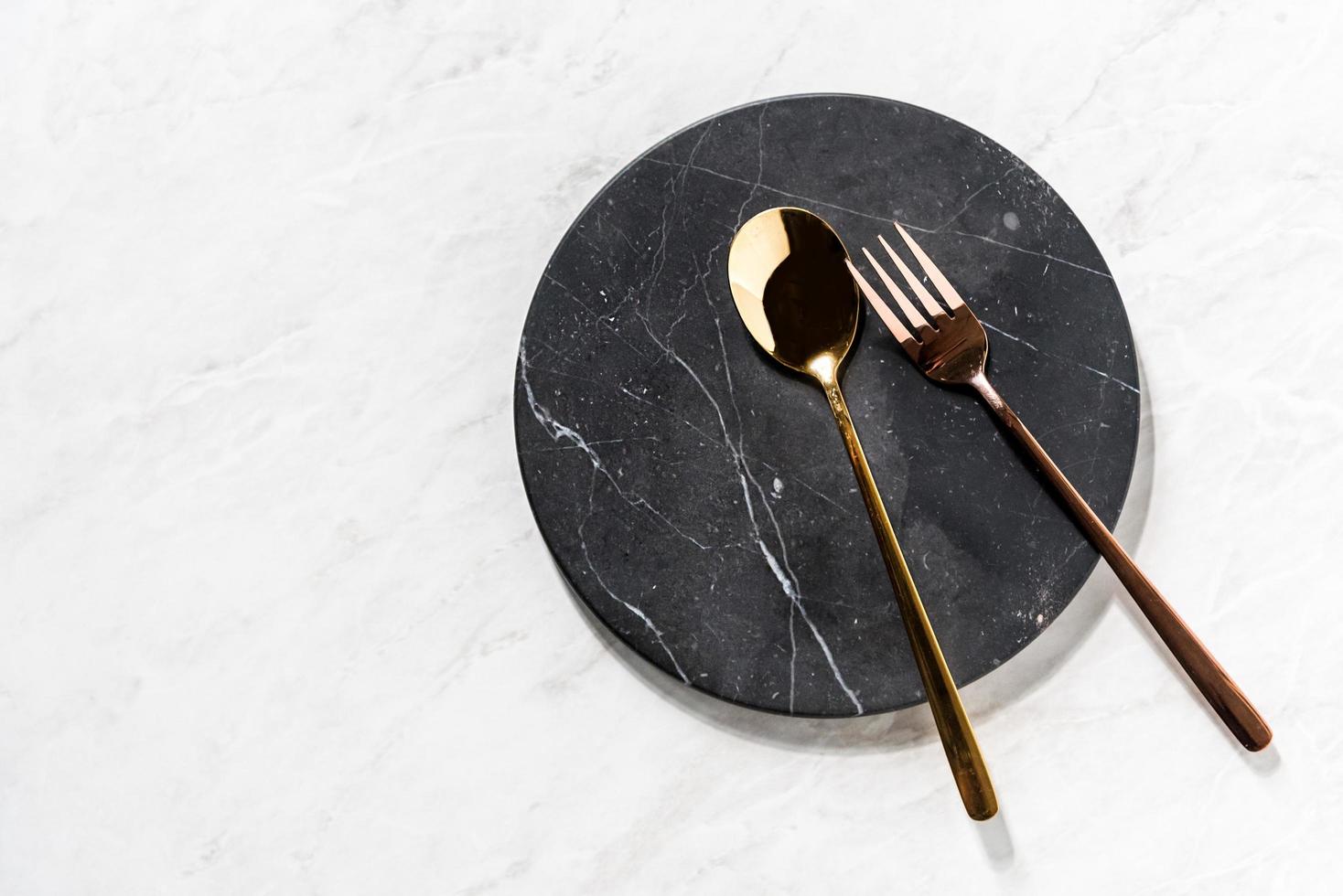 fork and spoon on a black marble tray photo