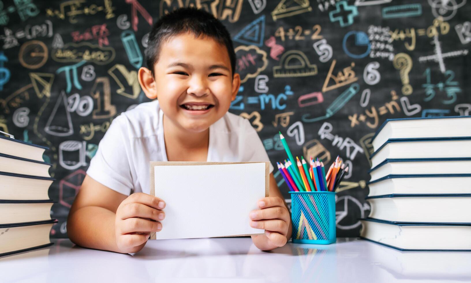 Child acting with envenlope in the classroom photo