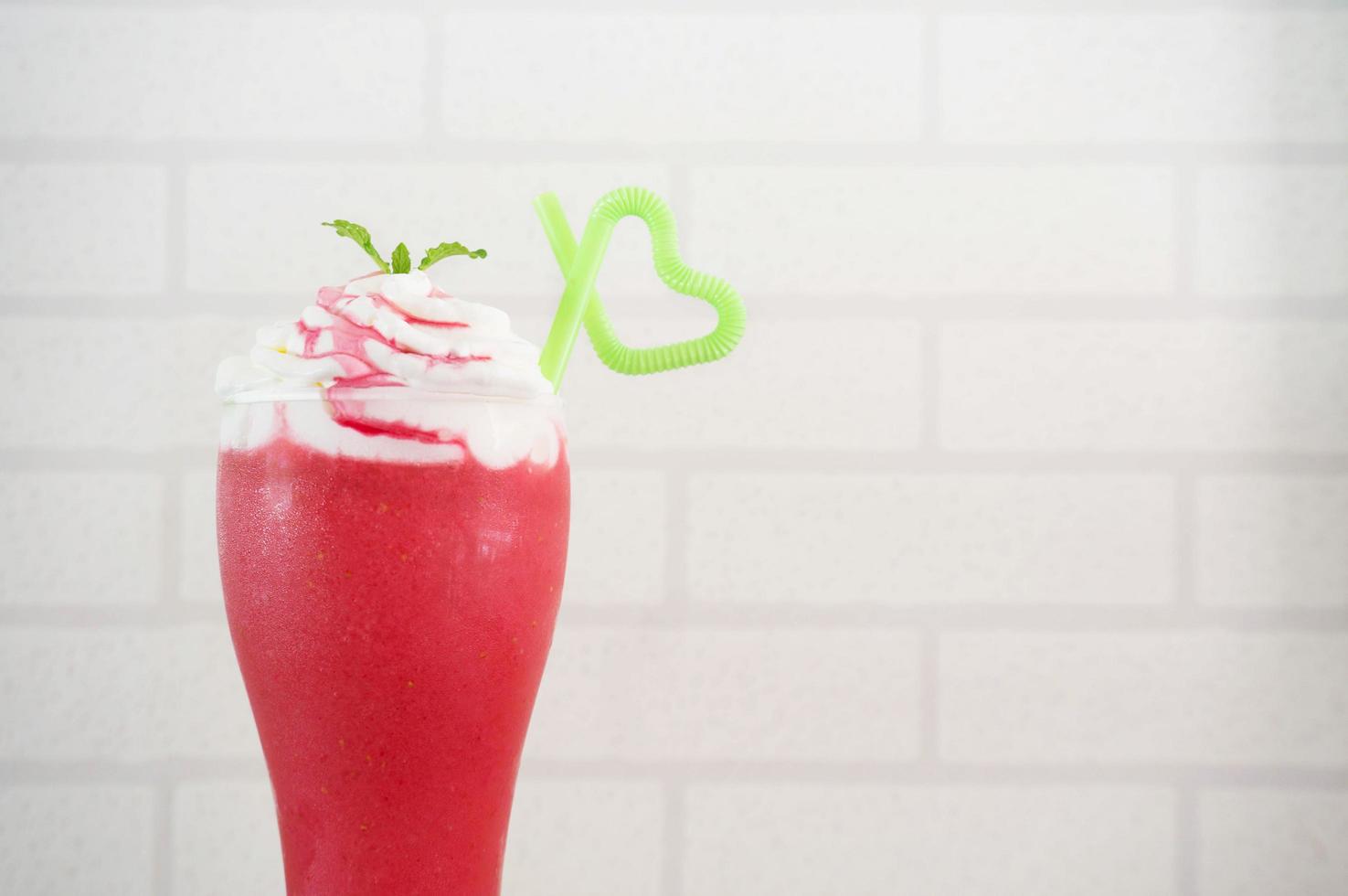 strawberry smoothie on white bricks background. photo