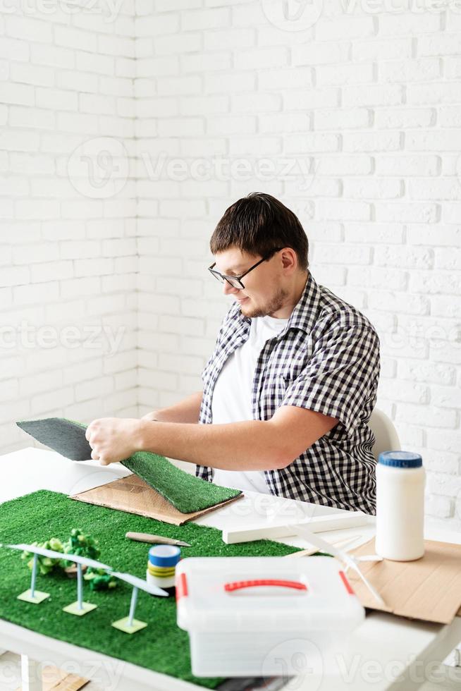 Young man making renewable energy project dummy photo