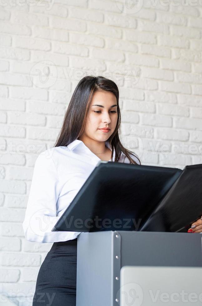 Portrait of young female lawyer working with documents photo